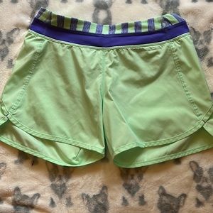 Ivivva workout shorts in mint green with purple. Size 14